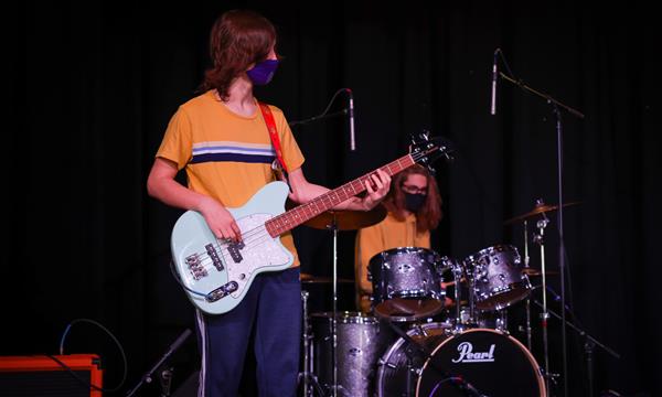 boys play guitars and drums